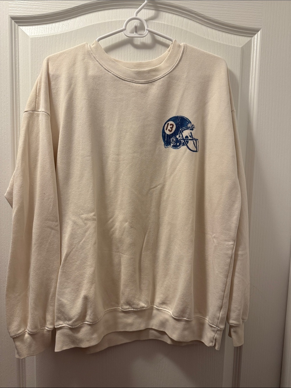 Dry Goods Cream Crewneck Sweatshirt with Blue Helmet Graphic